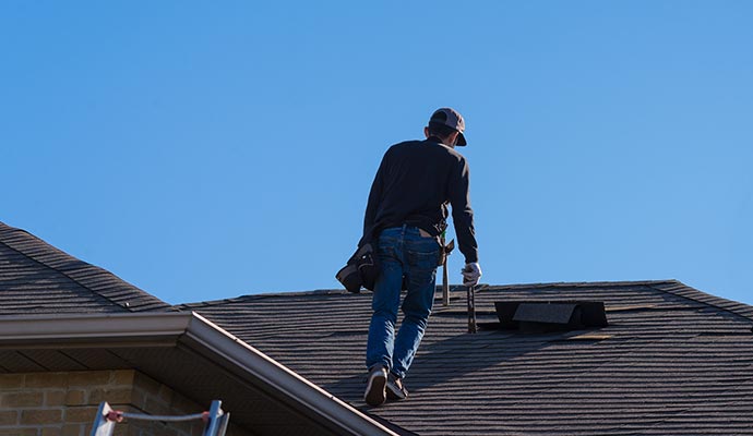 Professional inspecting a roof