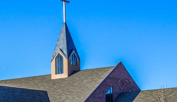 Church building roof with cross