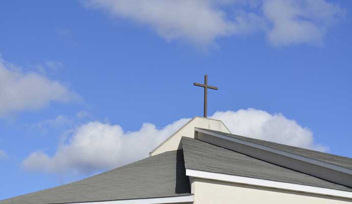 Church roof with a cross on top