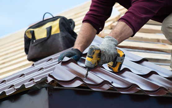 A skilled worker installing various types of roofing materials on a building.