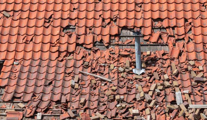 Close-up view of a damaged tile roof