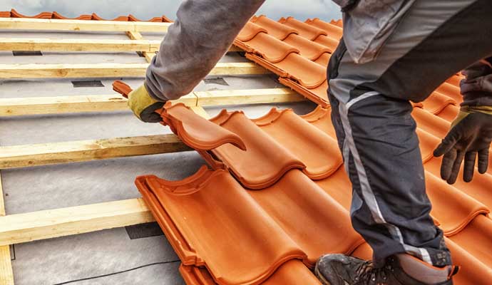 Professional installing a new tile roof