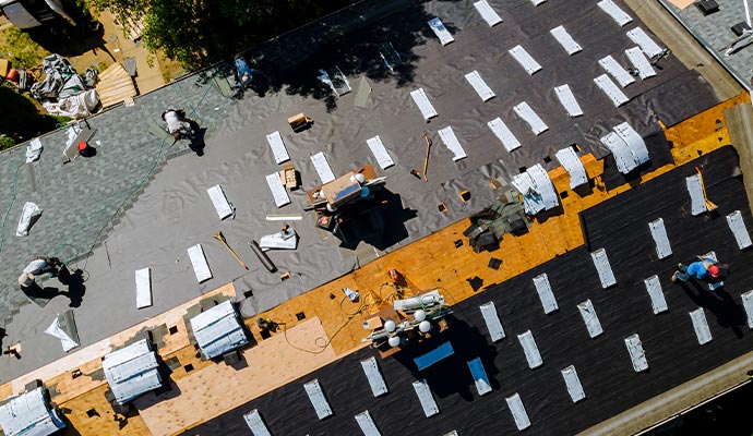 Person repairing the roof with equipment