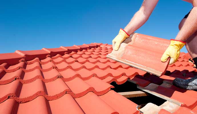 Professional repairing a tile roof