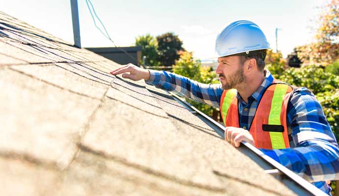 Professional inspecting a roof