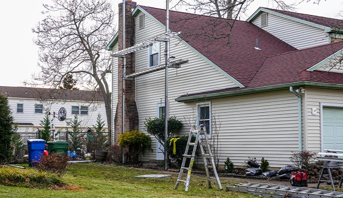 Team repairing house siding