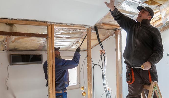 A person renovating the ceiling with equipment.