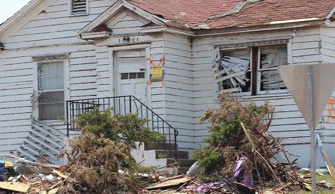 A damaged house with broken windows